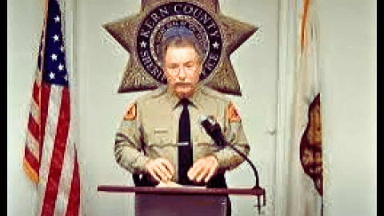 A man in uniform is speaking at a podium.