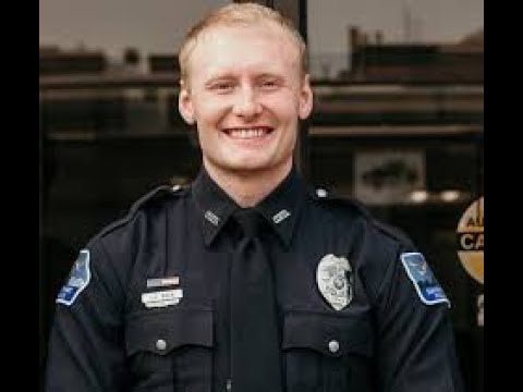 A police officer smiling for the camera.