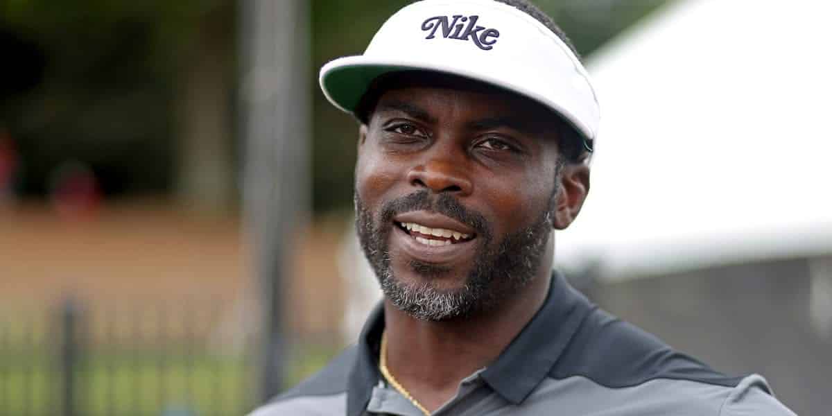 A man wearing a nike hat and smiling.