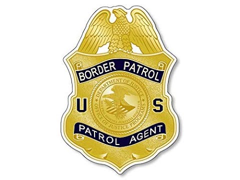 A yellow and blue badge with the words " border patrol patrol agent ".