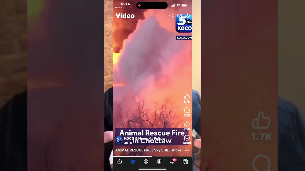 A person is taking a picture of smoke from the fire.