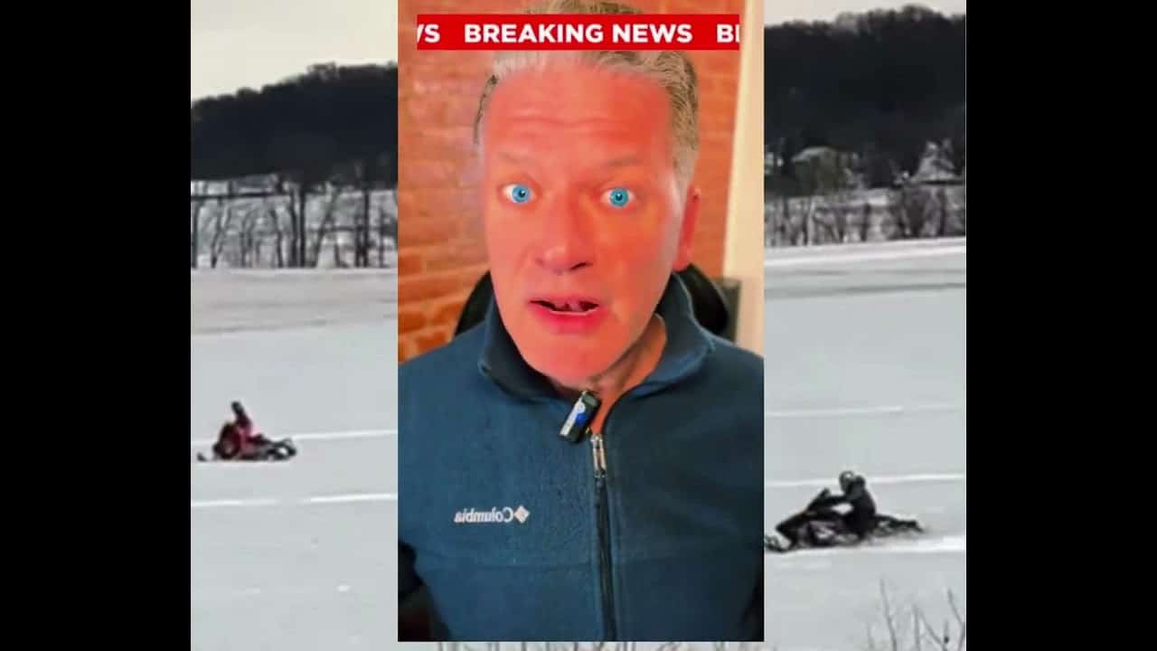 A man with red eyes and a blue jacket is looking at the camera.