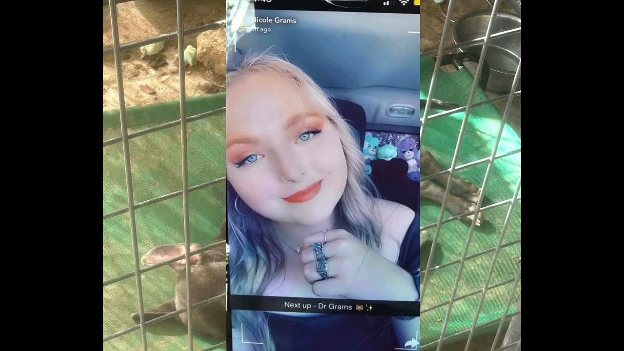 A woman is taking a selfie in her cell phone.