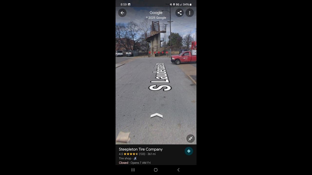 A street view of a road with cars parked on it.