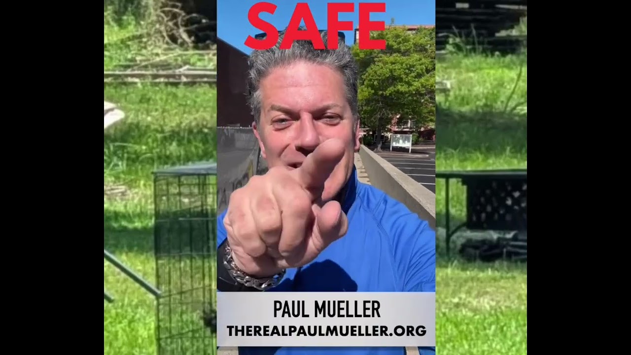 A sign with a man pointing to the camera.